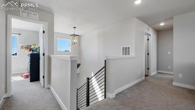 13358 Savannah Falls Ct, Peyton, CO 80831 - hall featuring an upstairs landing, visible vents, and carpet