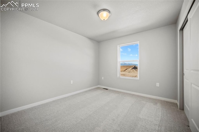 unfurnished bedroom with carpet floors and a closet