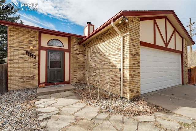 doorway to property with a garage