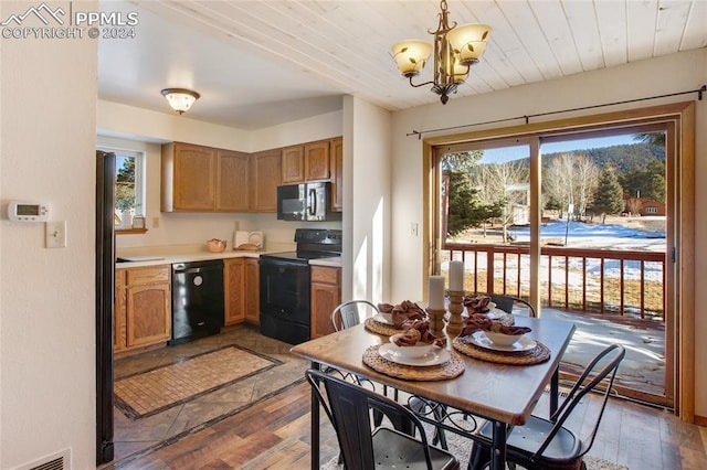 kitchen featuring wood ceiling, dark wood-type flooring, black appliances, decorative light fixtures, and a notable chandelier