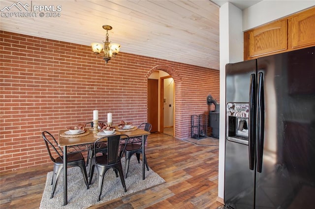 dining area with wooden ceiling, brick wall, dark hardwood / wood-style floors, and an inviting chandelier