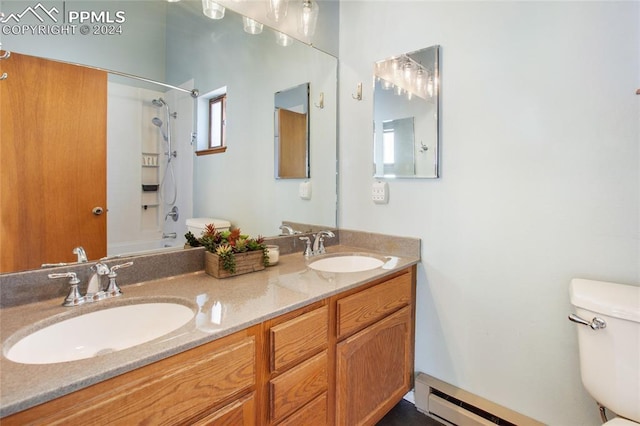 full bathroom featuring toilet, vanity, bathing tub / shower combination, and baseboard heating