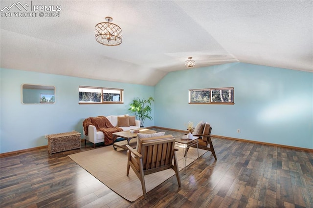 living room featuring dark hardwood / wood-style floors and vaulted ceiling