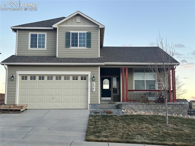 view of front property featuring a porch and a garage