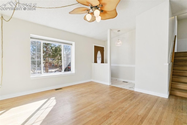 empty room featuring ceiling fan and light wood-type flooring