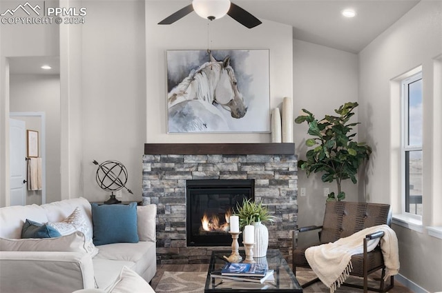 living room with ceiling fan, a fireplace, and a healthy amount of sunlight