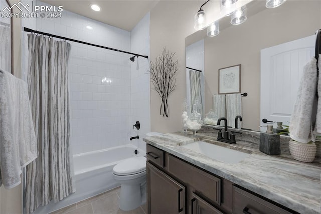 full bathroom with toilet, tile patterned floors, vanity, and shower / tub combo with curtain