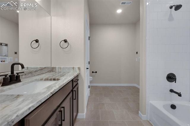 full bathroom with tile patterned floors, vanity, toilet, and tiled shower / bath