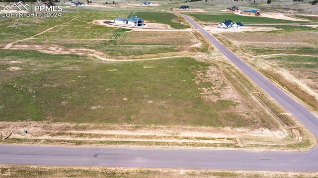 birds eye view of property with a rural view