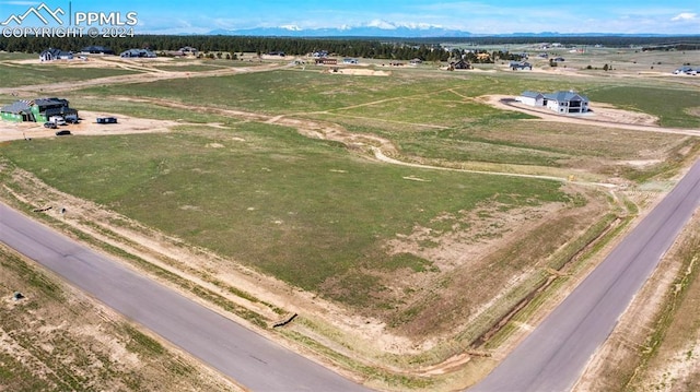 birds eye view of property with a rural view