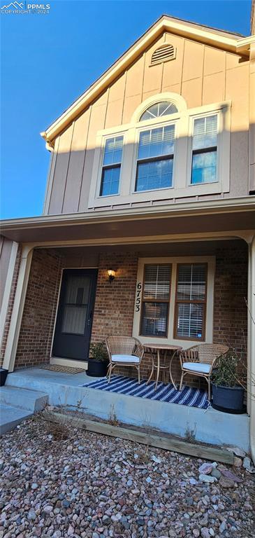 view of exterior entry featuring covered porch