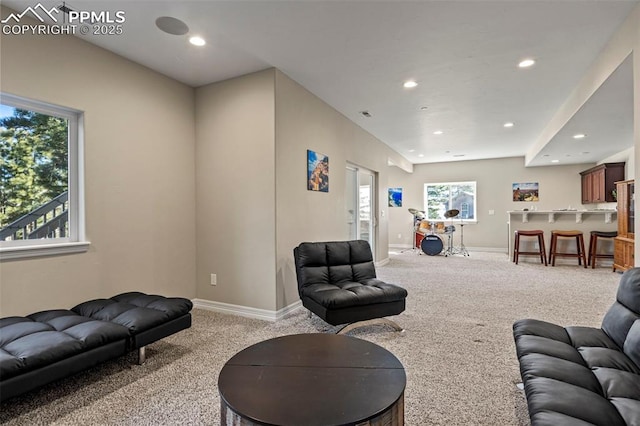 living room with light colored carpet and plenty of natural light