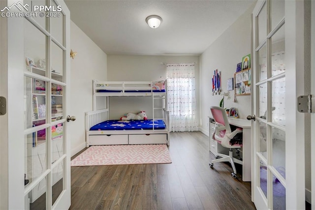 bedroom with dark hardwood / wood-style floors and french doors