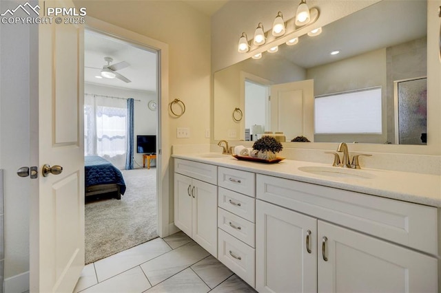 bathroom with tile patterned floors, ceiling fan, an enclosed shower, and vanity