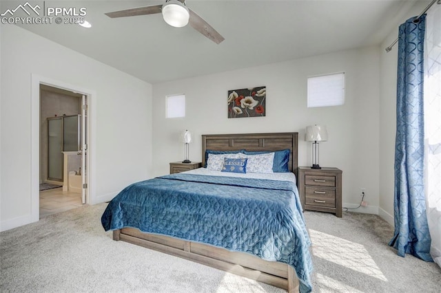 bedroom featuring connected bathroom, ceiling fan, and light colored carpet