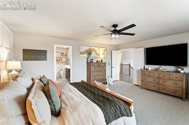 bedroom featuring ensuite bathroom, ceiling fan, and light carpet