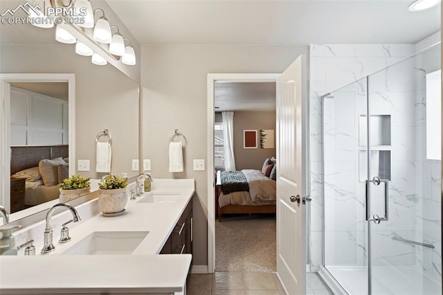 bathroom featuring tile patterned floors, vanity, and a shower with shower door