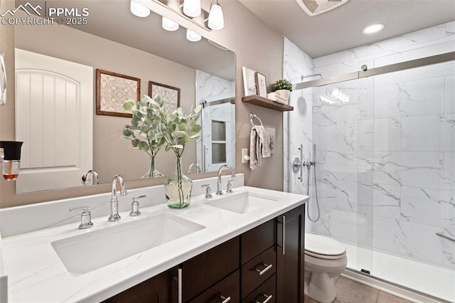 bathroom with tile patterned floors, vanity, toilet, and walk in shower