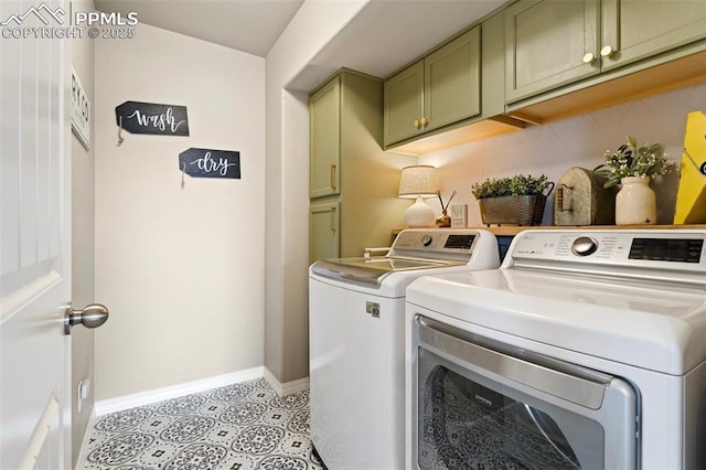 laundry room with cabinets and washing machine and clothes dryer