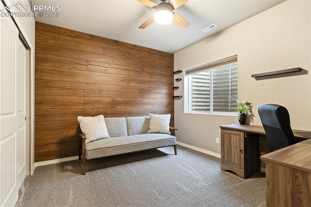 office featuring carpet flooring and wooden walls