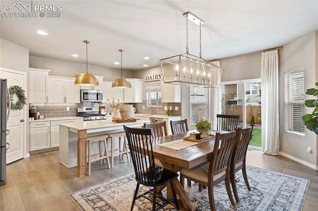 dining room featuring light wood-type flooring and sink