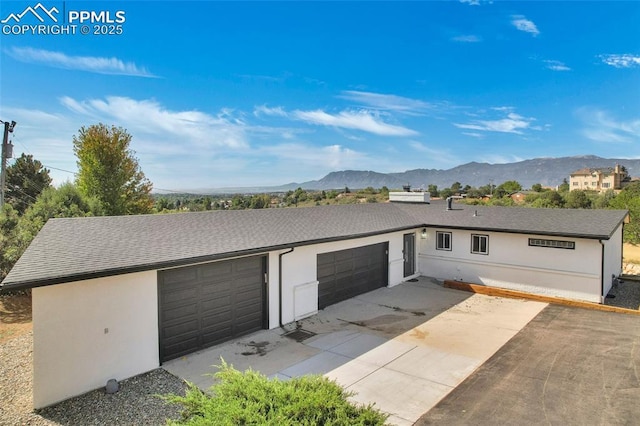 exterior space featuring a mountain view and a garage