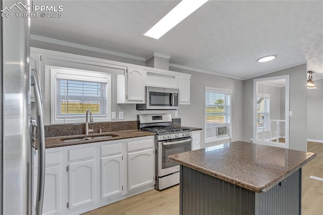 kitchen featuring lofted ceiling, sink, white cabinetry, and stainless steel appliances