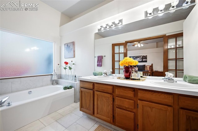 bathroom featuring tile patterned flooring, ceiling fan, a bath, and vanity