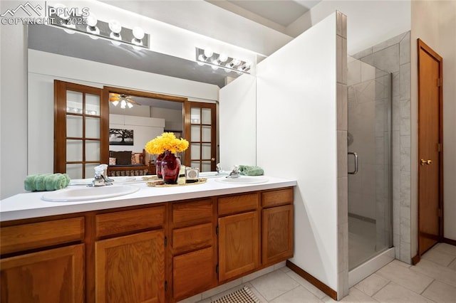 bathroom with vanity, an enclosed shower, tile patterned flooring, and ceiling fan