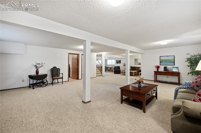 living room featuring a textured ceiling and light carpet