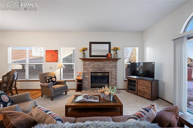 carpeted living room with a brick fireplace and plenty of natural light