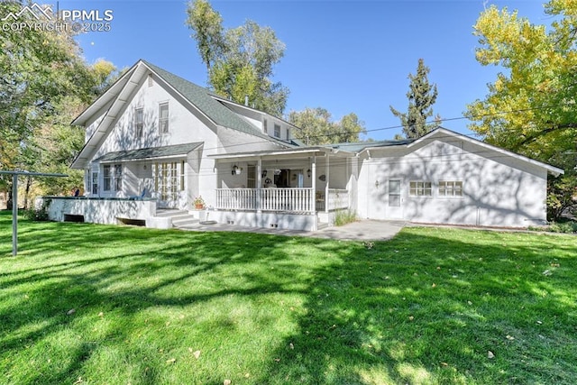 back of house with a lawn and a porch