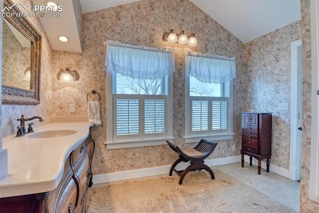 bathroom featuring tile patterned floors, vanity, and lofted ceiling