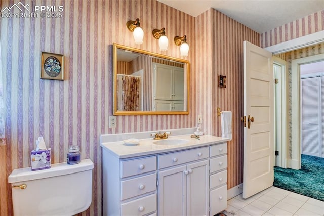 bathroom featuring toilet, vanity, and tile patterned floors