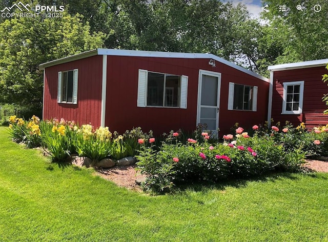 view of outbuilding featuring a yard