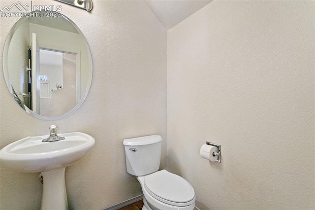 bathroom with vaulted ceiling and toilet