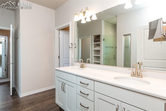 bathroom featuring vanity, hardwood / wood-style flooring, and a shower with shower door