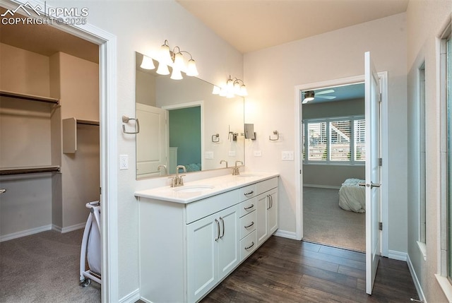 bathroom featuring hardwood / wood-style flooring, vanity, and ceiling fan