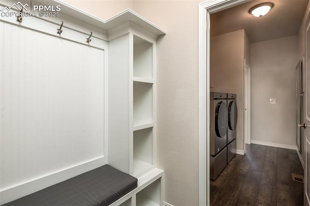 mudroom with dark wood-type flooring and independent washer and dryer