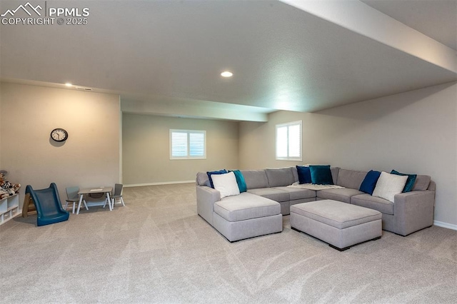 living room with light carpet and a healthy amount of sunlight