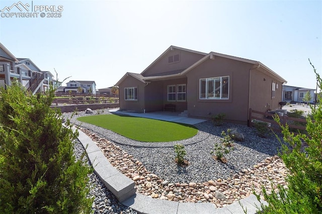 rear view of property with a yard and a patio