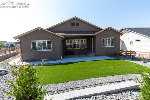 rear view of property with a yard and a patio