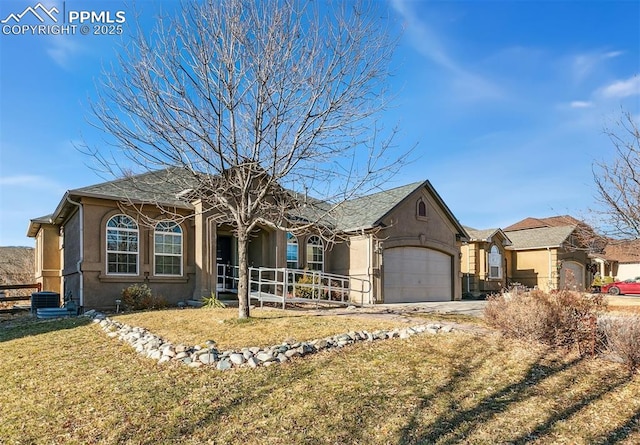 single story home with a garage and a front lawn