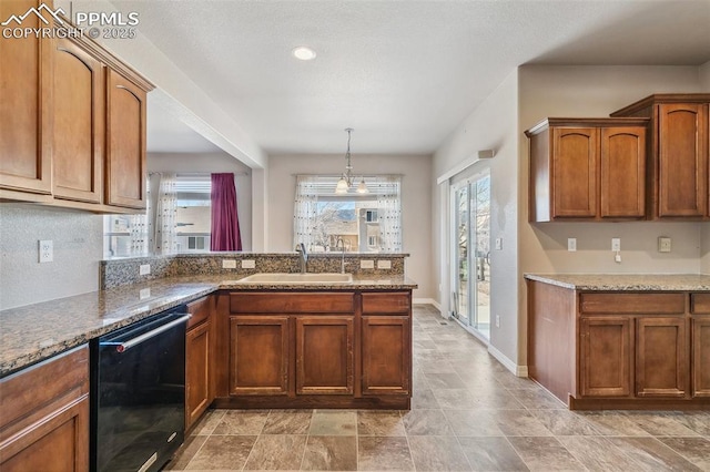 kitchen with stone counters, black dishwasher, decorative light fixtures, and sink