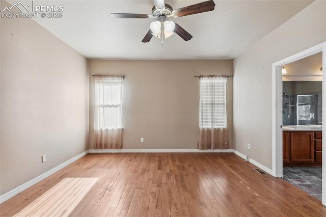 empty room featuring hardwood / wood-style floors and ceiling fan