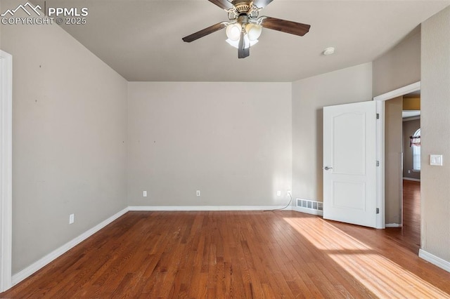 unfurnished room with hardwood / wood-style floors and ceiling fan