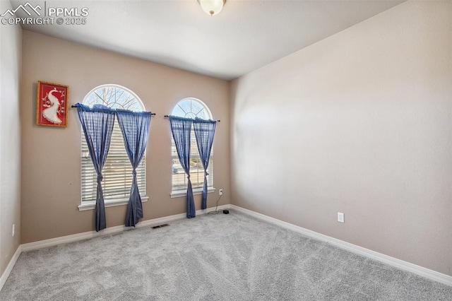 empty room featuring light colored carpet