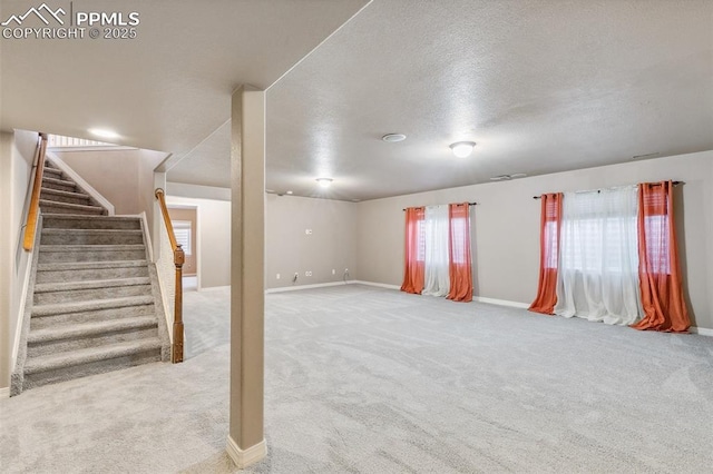 basement with carpet floors and a textured ceiling