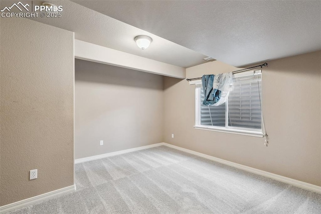 basement with light carpet and a textured ceiling