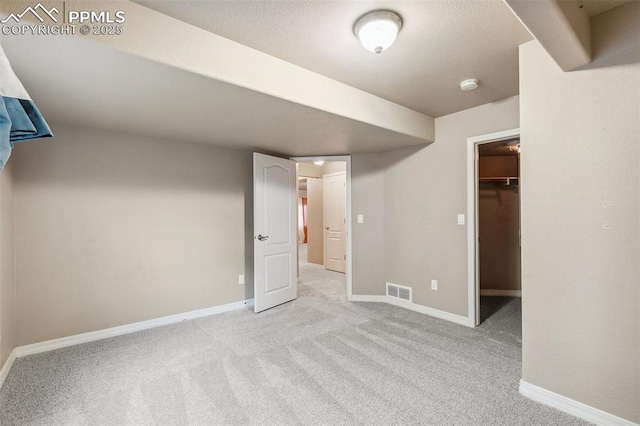 basement featuring light carpet